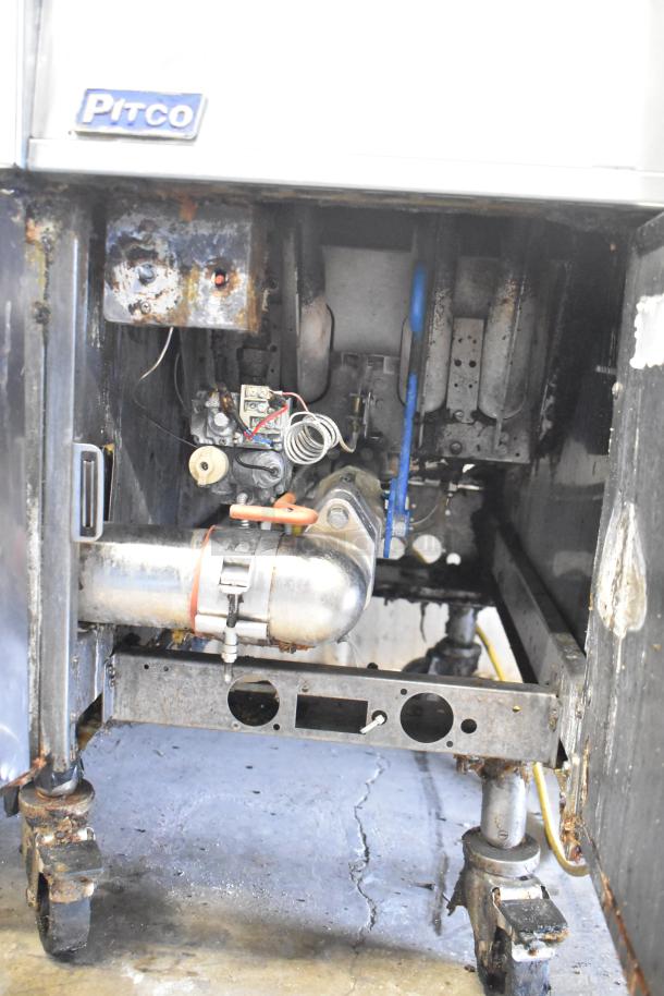 Pitco Frialator stainless steel 4-bay commercial deep fat fryer, 122,000 BTU, on casters, natural gas-powered, used condition.