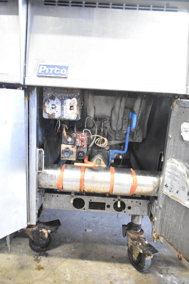 Pitco Frialator stainless steel 4-bay deep fat fryer, natural gas, 122,000 BTU, on commercial casters, visible wear.