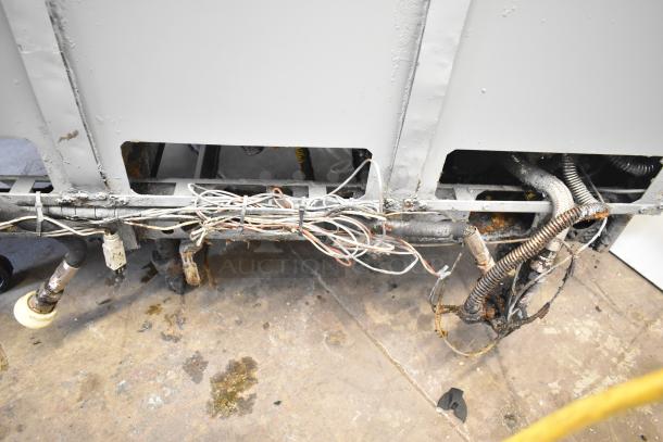 Pitco Frialator 4-bay stainless steel deep fryer, natural gas, on casters. Visible wiring and signs of wear. 122,000 BTU.