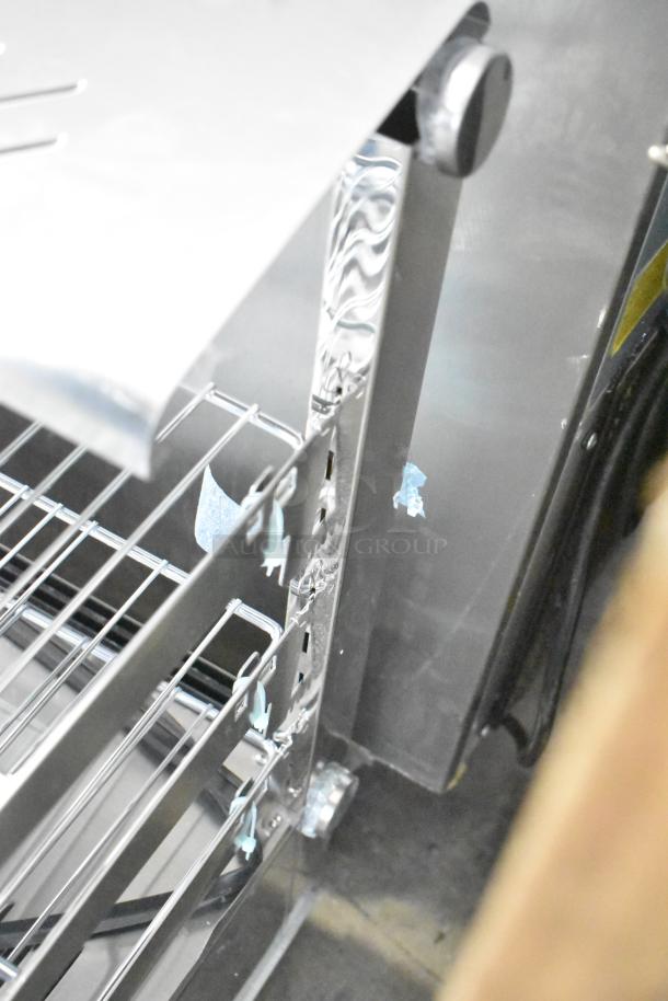 ServIt 423HDM26SA 26" heated display case, scratch and dent, three shelves, sliding doors, broken glass visible.