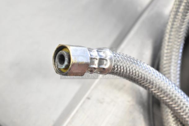 Close-up of the Frymaster 8CSC pasta cooker's metal hose connector, showcasing durable braided steel construction.