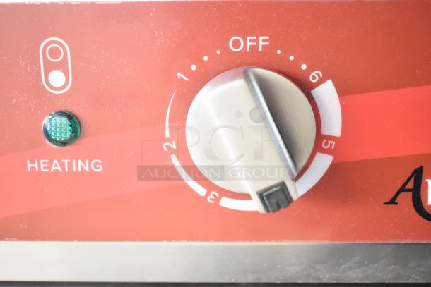 Close-up of Avantco 177CER200 range control knob set to off with "Heating" indicator and numeric settings.