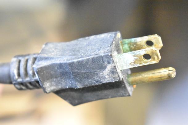 Close-up of a worn electrical plug with visible corrosion, part of the Cleveland BPAN-1001 Commercial Braising Pan.