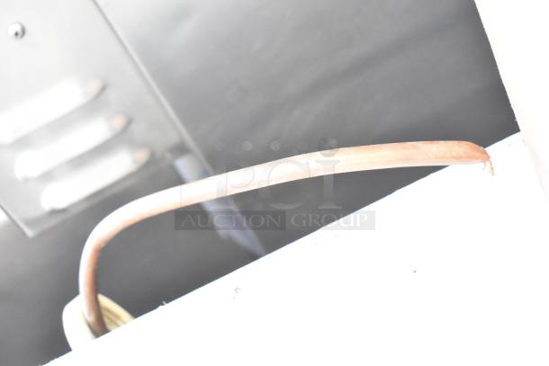 Ice-O-Matic ICEU220HA1 ice machine tubing detail. 115 volts, 1 phase. Undercounter, self-contained. Model visible.