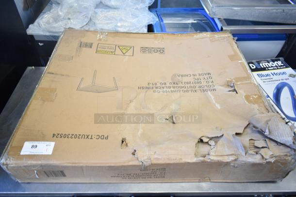 Cardboard box with Flash Furniture XU-DG-UH8100-GG patio table, faux teak top, black steel base. Box is damaged.