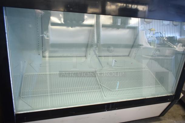 Commercial floor-style deli display case, 208 volts, 1 phase, with two wire shelves and clear glass front, used condition.