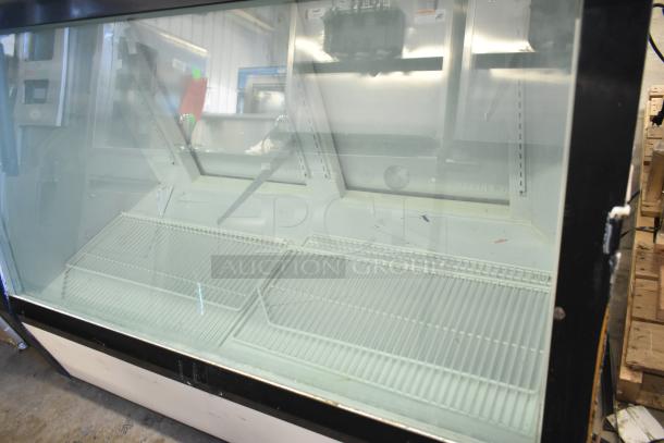 Commercial floor-style deli display case, 208 volts, 1 phase. Features glass front and wire shelves. Good condition.