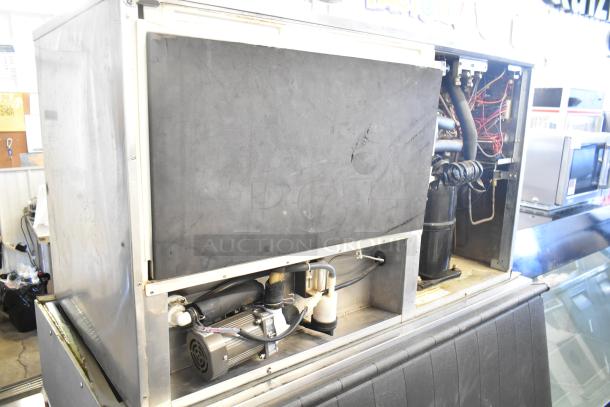 Hoshizaki KM-1301SWH commercial ice machine head on ice bin, 208-230V, 1 phase, visible wiring and components, used condition.
