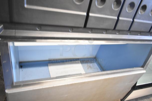 Hoshizaki KM-1301SWH commercial ice machine head on ice bin, 208-230V, 1 Phase, in good condition.