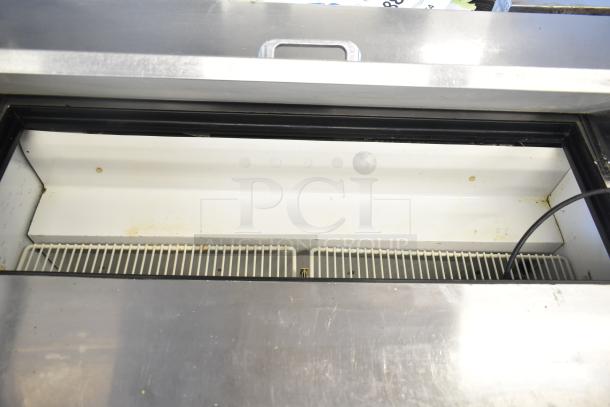 True TSSU-48-12 commercial prep table with bain marie top, on casters. Shows interior, 115V, 1 phase. Minor wear visible.