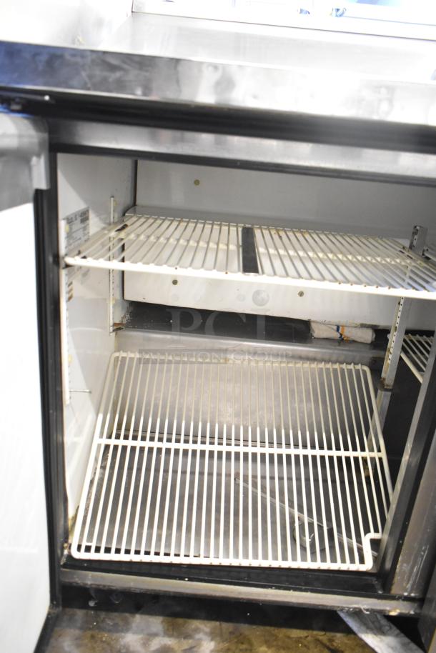 True TSSU-48-12 sandwich prep table in good condition, with shelves, visible label, on commercial casters, 115V, 1 phase.