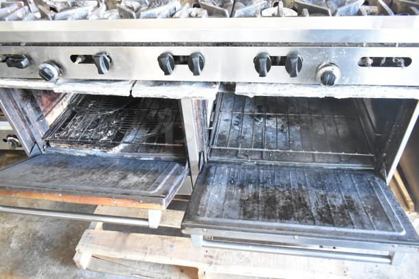 Garland SunFire commercial gas range with 10 burners, 2 ovens, over shelf, and backsplash. Used condition, stainless steel.