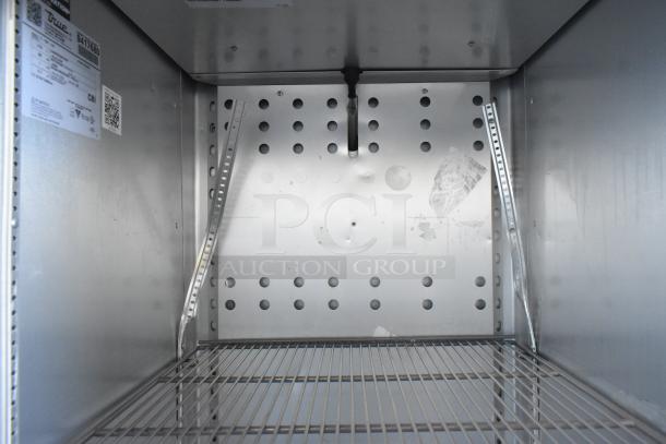 2018 True T-23F-HC commercial single door reach-in freezer, interior view, metal shelving, perforated back panel.