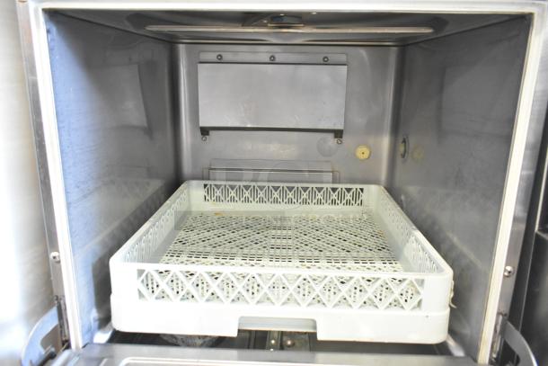 Hobart Advansys undercounter commercial dishwasher, clean interior, includes dish rack, stainless steel construction.