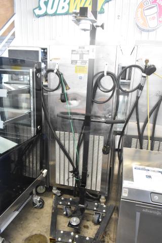 Fantom Full Web Portable Shrink Wrapping Station, durable build, various attached cords, minor wear, ideal for packaging applications.