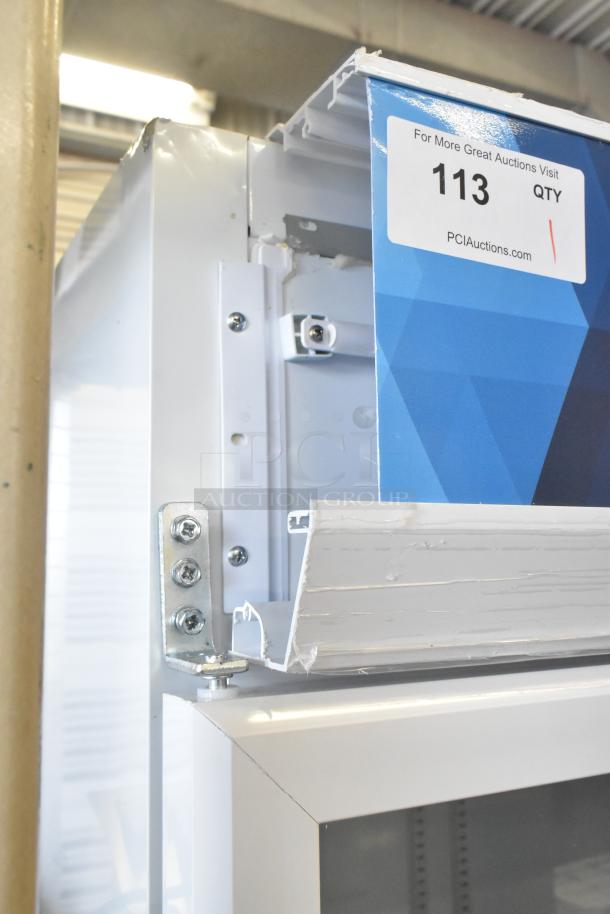 KoolMore KM-MDR-2GD-35 commercial cooler with minor dents, visible metal frame, auction tag reads "113 QTY PCIAuctions.com".