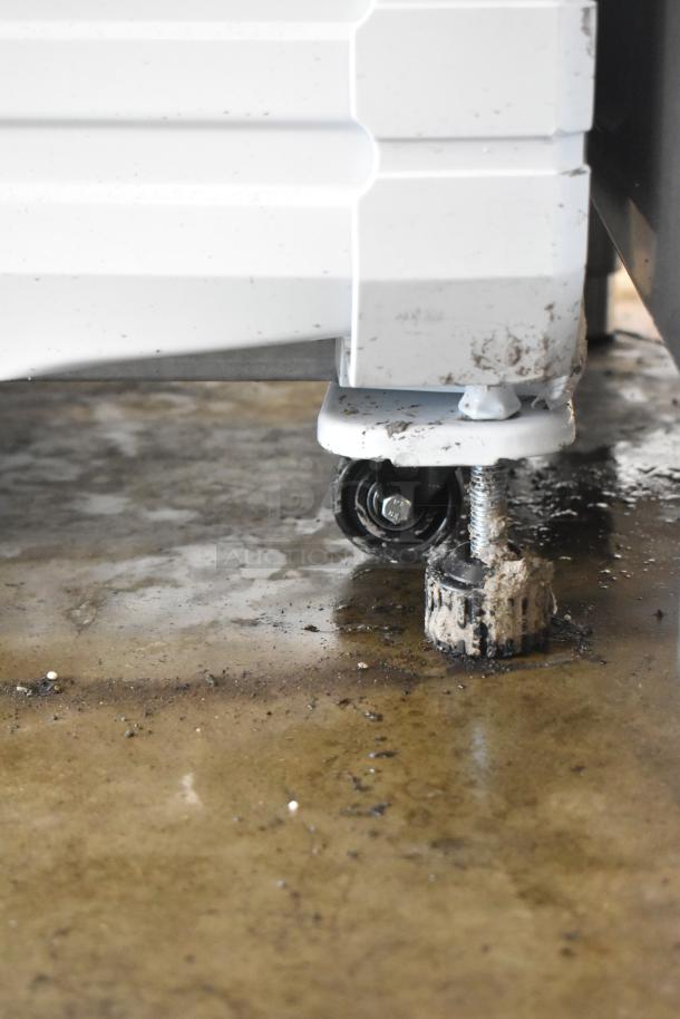 KoolMore KM-MDR-2GD-35 cooler caster on wet floor, visible scuff marks, supports easy movement. 115V, 1 Phase.