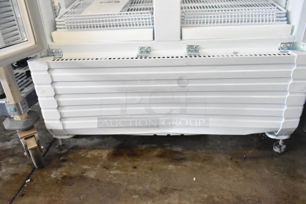 KoolMore KM-MDR-2GD-35 commercial cooler, new with dents, on casters. 2-door merchandiser, 115V, 1 phase.
