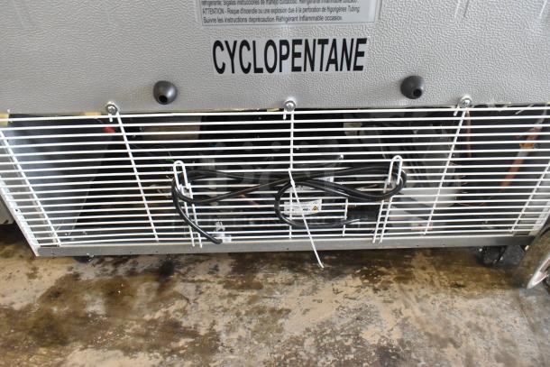 KoolMore KM-MDR-2GD-35 cooler on casters showing rear vent, cord, and Cyclopentane label. Brand new scratch and dent.