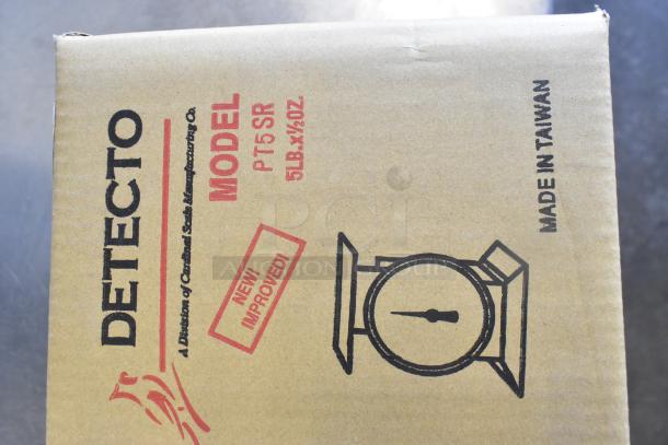 Brand new Detecto PT-5-SR 5 lb. stainless steel portion control scale. Features rotating dial, scratch and dent condition, model 308PT5SR. Box labeled "Made in Taiwan."