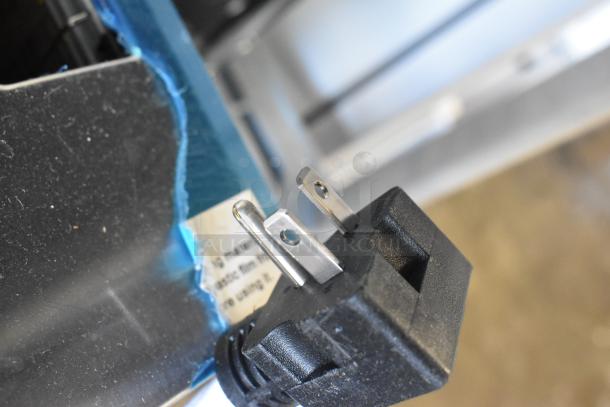 Close-up of Avantco 184THD27208 toaster plug showing standard electrical prongs. Slight scratch visible on metallic surface.