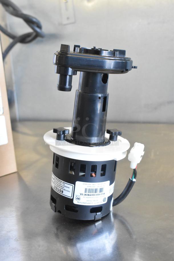 Brand new Ice-O-Matic 9161144-01S pump kit, 115V, 50/60Hz. Slight scratch and dent. Labels indicate model and specs.