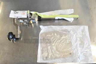 Brand new Hamilton Beach HCO500 manual side cut can opener, heavy-duty #10, with minor scratches and dents, auction tag visible.