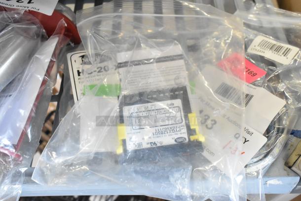 Three new items in bags: Galaxy 177LED34 LED light, Carel PZGXSOJ111 control component, Steril-Sil HC-20-X lid.