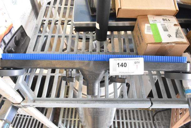 Brand new vacuum attachment, scratch and dent. Blue bristle edge, minor cosmetic imperfections. Lot tag indicates item 140.