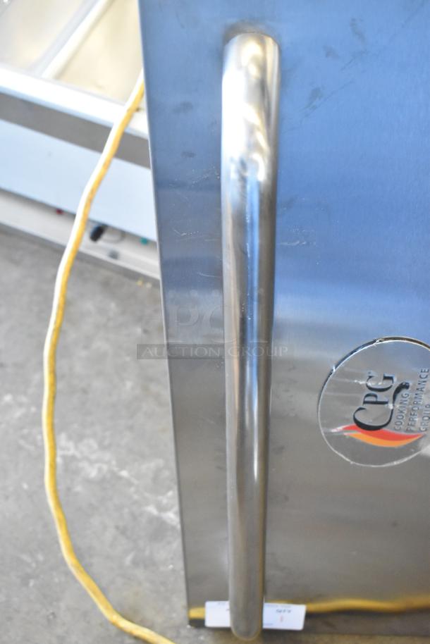 Stainless steel Cooking Performance Group oven door, brand new with scratches, logo visible, sturdy handle.