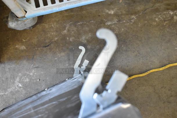 Brand new Cooking Performance Group CPG oven door with visible scratches and dents, metal latches shown.