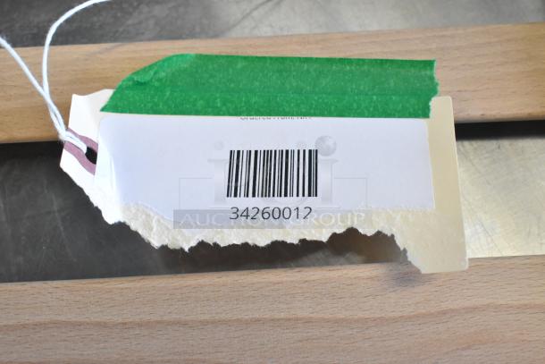 Barcode tag with number 34260012 on AvaValley rack, showcasing new scratch and dent items for auction.