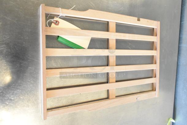 Wooden AvaValley rack with five slats, brand new, on metal surface, with a tag attached. Ideal for storage use.