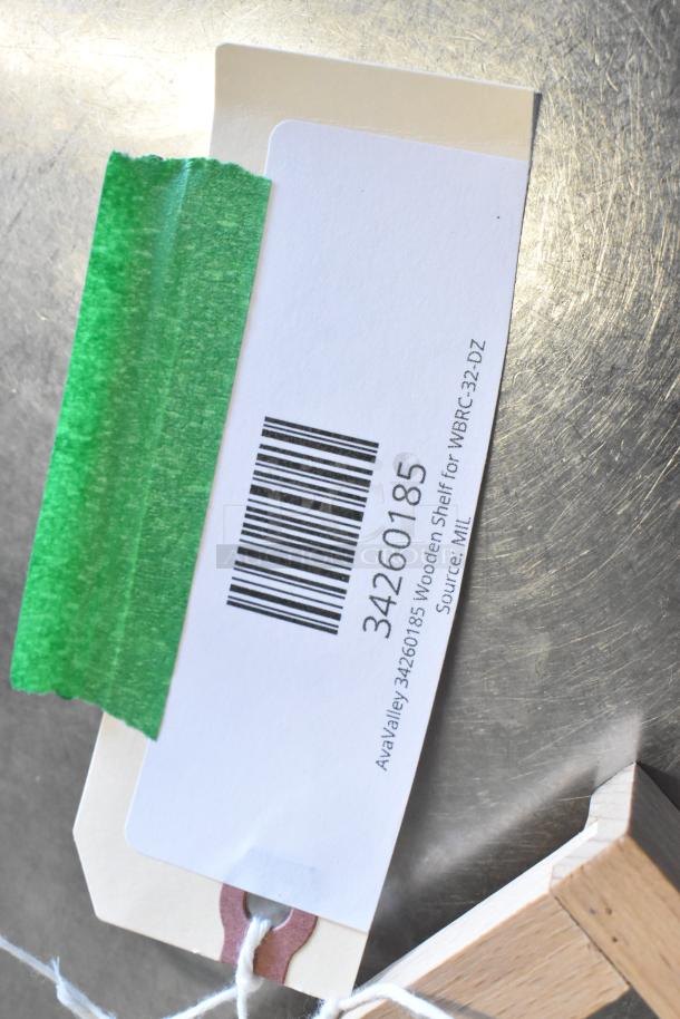 Alt text: AvaValley tag reads "34260185 Wooden Shelf," taped on a metal surface with a green tape.