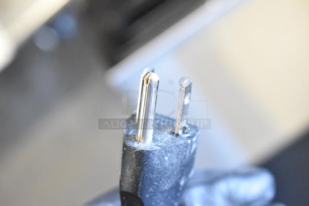 Close-up of a three-prong electrical plug from a 2017 Bunn VPR 12 Cup Coffee Brewer, indicating 120-volt operation.