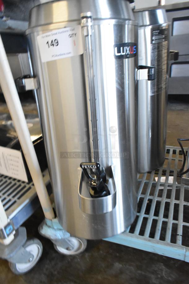 Brand new 2024 Fetco TPD-30 Luxus stainless steel 3-gallon coffee dispenser, scratch and dent condition, labeled.