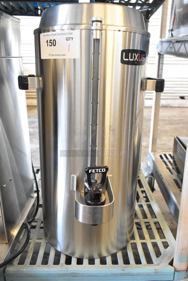 Brand new Fetco TPD-30 Luxus 3-gallon coffee dispenser, stainless steel. Scratch and dent. Visible Luxus and Fetco logos.