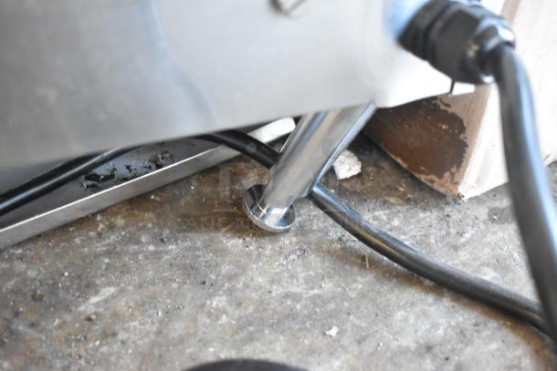 Close-up of the Avantco 184T3600B conveyor toaster leg and power cord on a concrete surface, showing durable construction.
