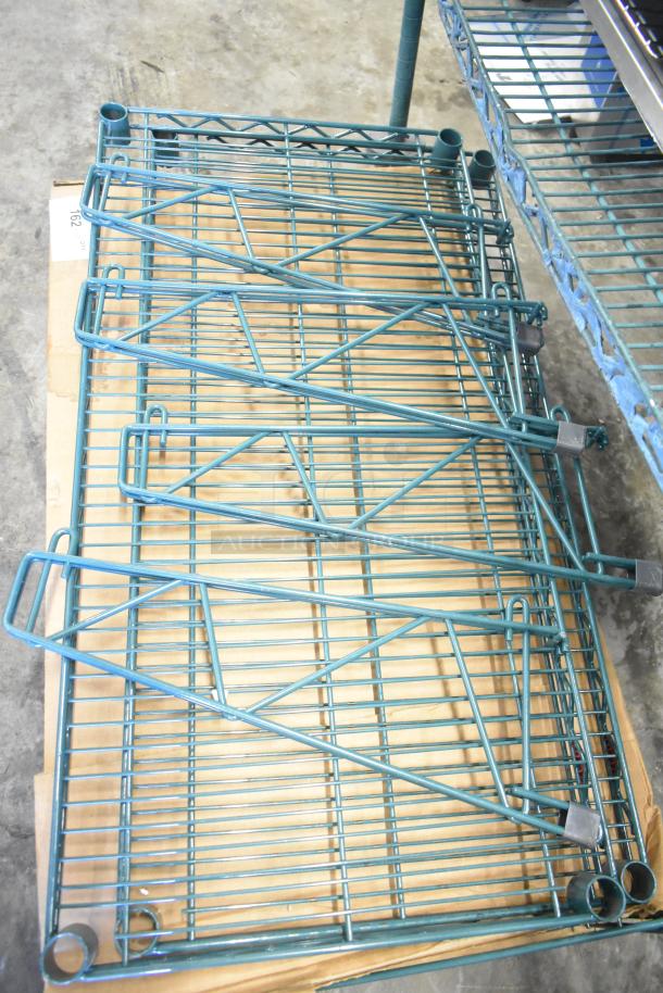 7 items including 4 green finish brackets, 2 Metro green wire shelves, and Metro GS1836K3 grid shelf on cardboard.