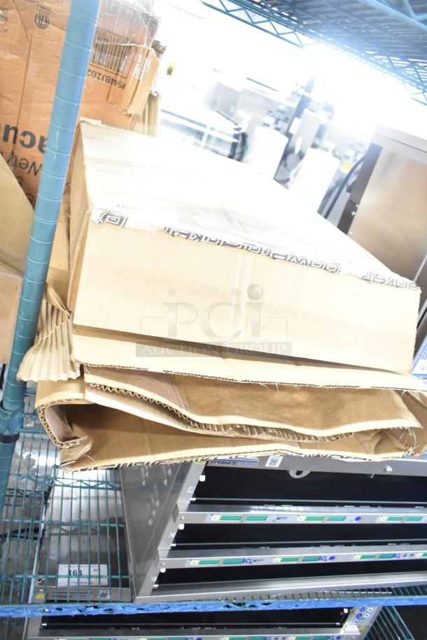 New Powerblanket GCW40 gas cylinder heater cover in original cardboard box on metal shelf. Box marked “Powerblanket.”