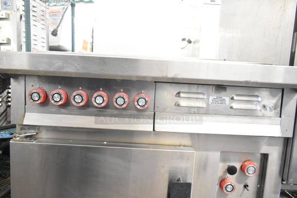 Lang RTI36E commercial induction range, 6 burners, 208/240V, 3 phase, stainless steel, red knobs, several visible dials.
