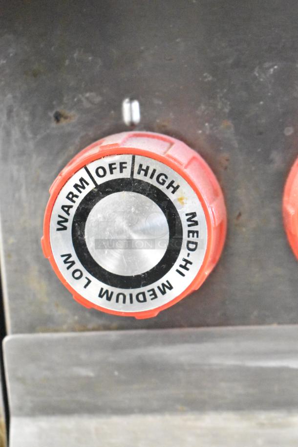 Lang RTI36E induction range control knob. Settings: off, warm, low, medium, med-hi, high. Red with silver center.