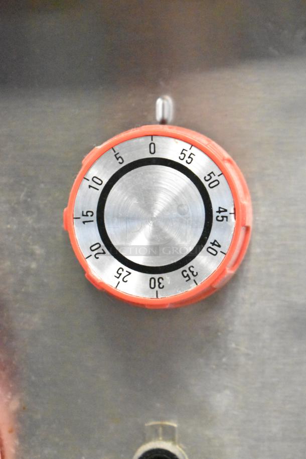 Lang RTI36E timer dial on commercial electric induction range, stainless steel, red knob, clear markings.