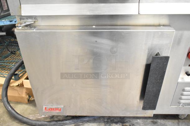 Lang RTI36E commercial electric induction range, 6 burners, 208/240 volts, 3-phase. Stainless steel, visible wear, Lang logo.