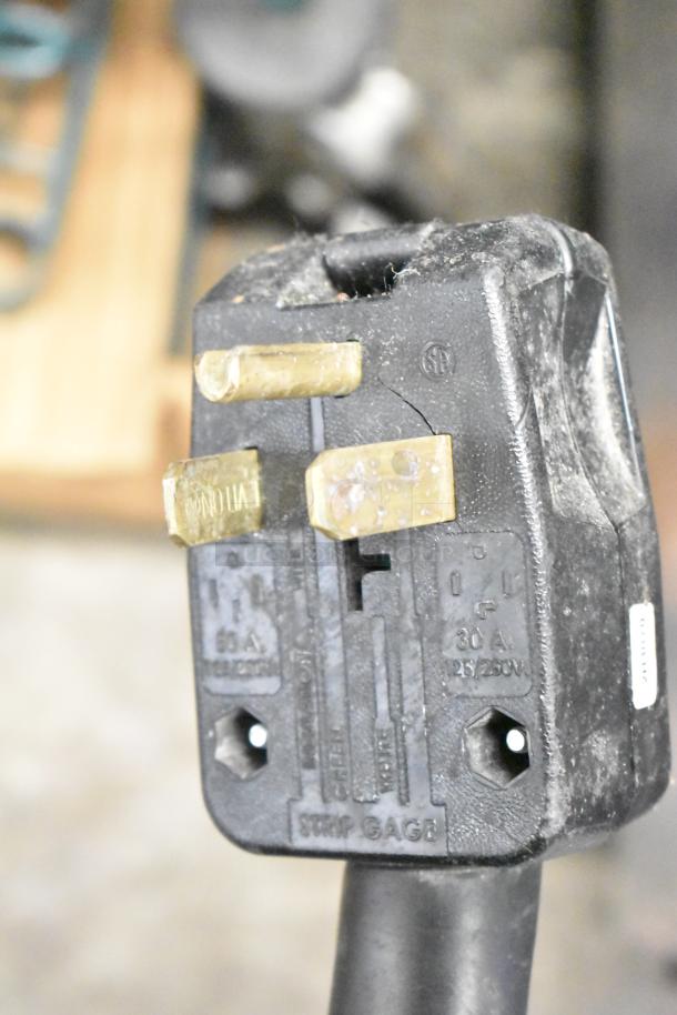 Close-up of the Lang RTI36E range power plug, labeled 30A, 125/250V, 3 phase. Plug shows some wear and markings.