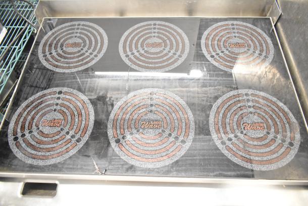 Lang RTI36E 6-burner induction range, electric, 208/240V, 3 phase. Features Lang Wave markings, in used condition.