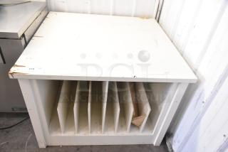 White counter with divided storage slots below. Visible wear on edges. Tag reads "173 QTY." Suitable for organizing.