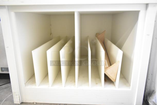 White counter with vertical dividers for storage, moderate wear, includes a small triangular wooden piece, numbered 1303.