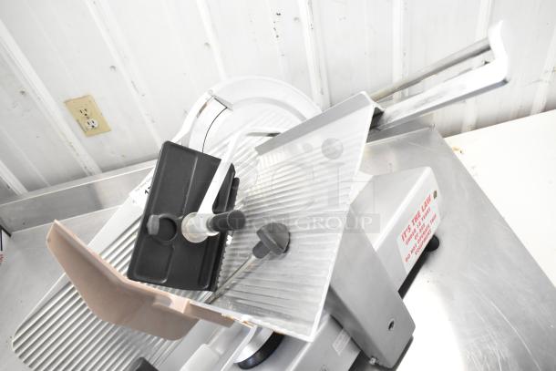 Bizerba commercial countertop meat slicer, 120 volts, 1 phase. Features stainless steel blade, safety guard, and power switch.