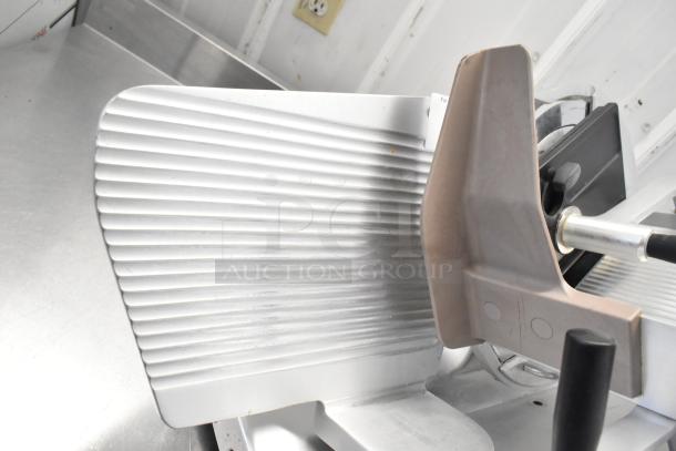 Bizerba commercial countertop meat slicer, metal finish, 120 volts, 1 phase, lightly used, visible blade and guide plate.